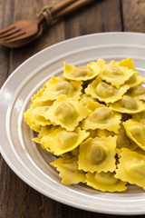 Plate of ravioli with on wood table
