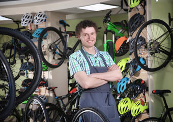 Young man standing in bicycle shop