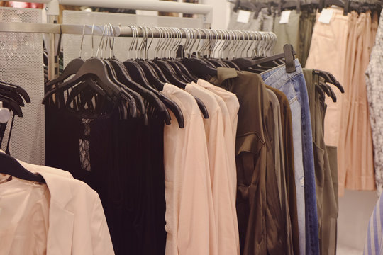 Different female clothes in modern shop