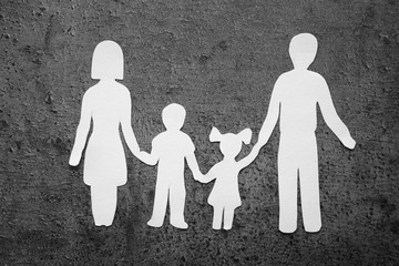Paper silhouette of family on grey background. Life insurance concept