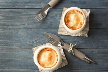 Baking cups with delicious turkey pie on wooden table