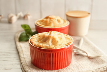 Baking cup with delicious turkey pie on table