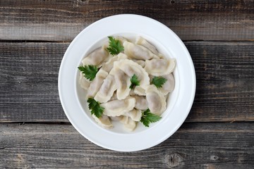 Delicious homemade ravioli with parsley in a plate   