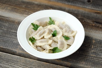 Delicious homemade ravioli with parsley in a plate   