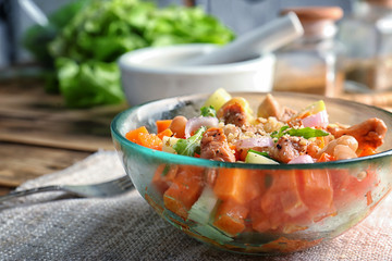 Bowl with delicious carrot salad on table