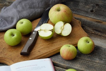 Fresh green rustic apples on a grey background