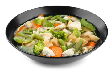 Bowl with delicious turkey soup on white background