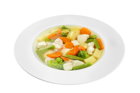 Plate with delicious turkey soup on white background