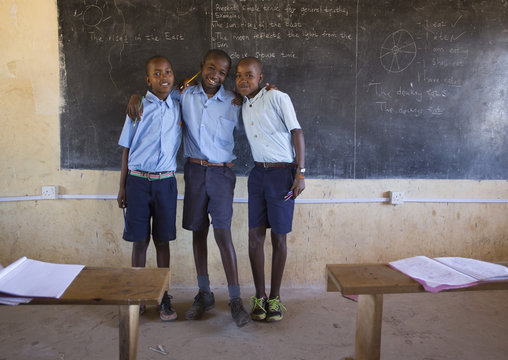 Portrait of smiling students standing in the classroom