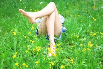 Woman lying on green grass