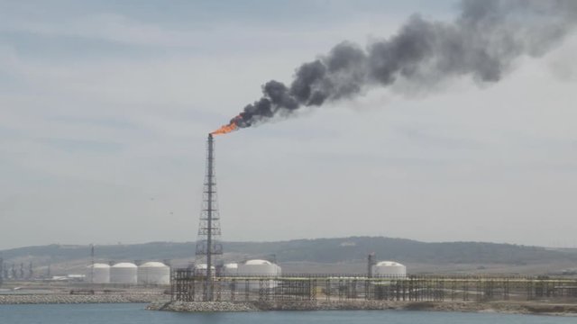 Smoke and burning gas from industrial tower