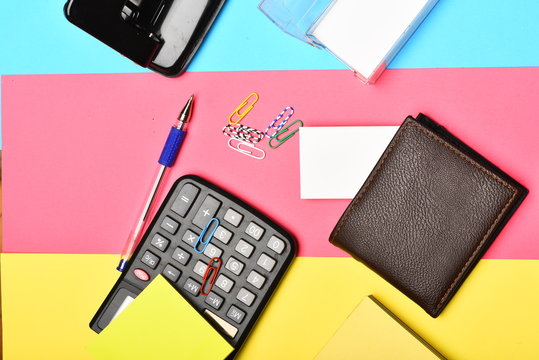 Calculator, Hole Punch, Business Card Holder On Colourful Background