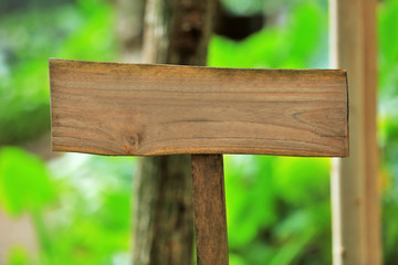 Blank wooden directional sign outdoors, closeup