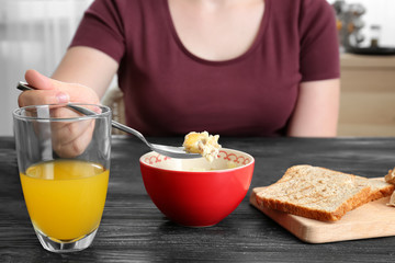 Woman eating tasty lunch and drinking fresh juice