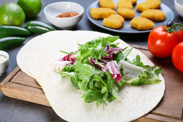 Delicious fish taco with filling on  grey background, close up