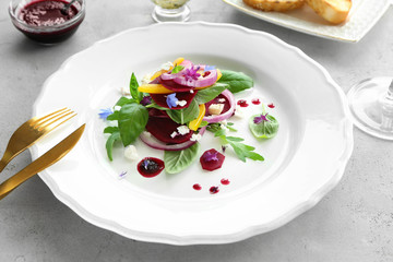 Plate with useful beet salad on table