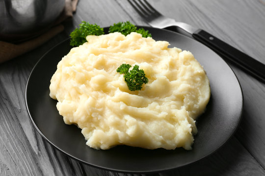 Plate with mashed potatoes on wooden table