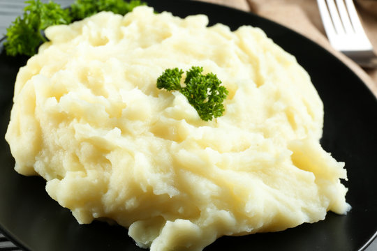 Plate with mashed potatoes on table, closeup
