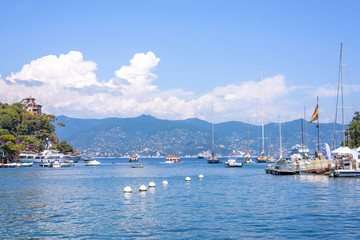 Fototapeta na wymiar Daylight view to ships cruising on water near Portofino city in Italy