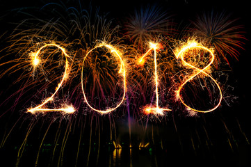 HAPPY NEW YEAR 2018 from colorful sparkle on black background Fireworks light up the sky,New Year...