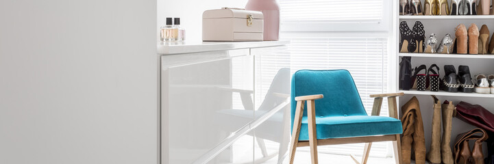Pink box and perfumes on glossy commode