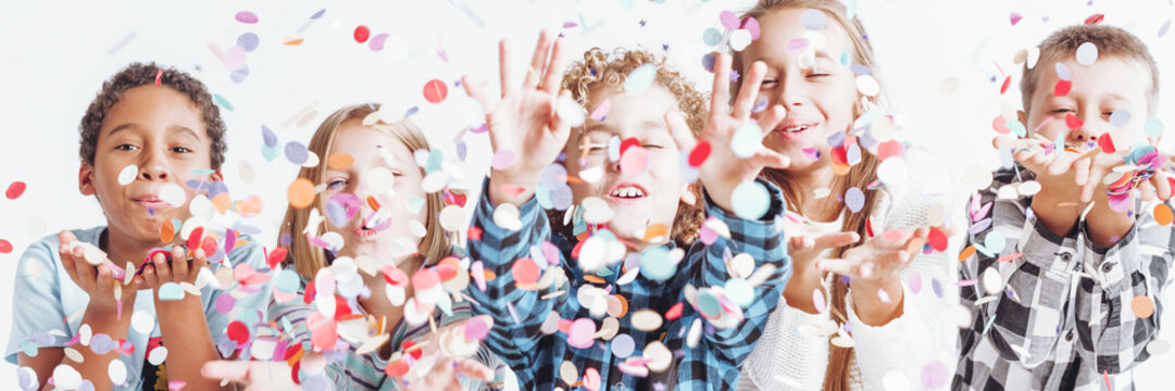 Group of children throwing confetti