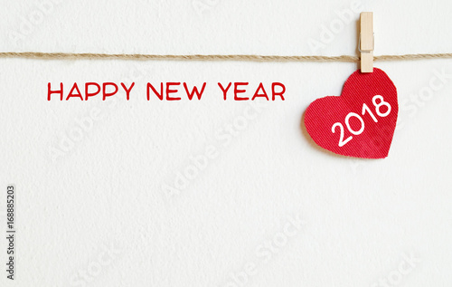 red fabric heart with happy new year 2018 word hanging on the