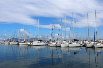Fototapeta na wymiar Marina view. Sailing boats in the harbour in Sardinia 