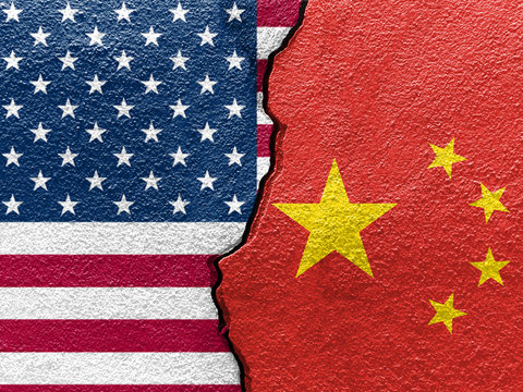 U.S.A. and China's flags on cracked wall (Concept of international conflict)