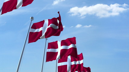 Row of waving flags of Denmark agaist blue sky, 3D rendering