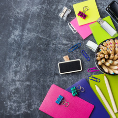 School stationery, supplies, pencil, pen, note on grunge chalkboard