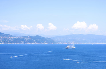 Daylight view from top to ships cruising on water near Portofino city in Italy.