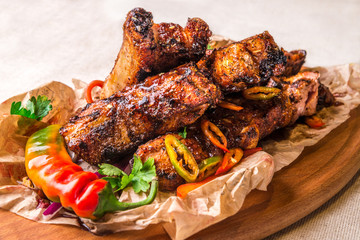 Appetizing grilled ribs decorated with hot pepper. Horizontal frame