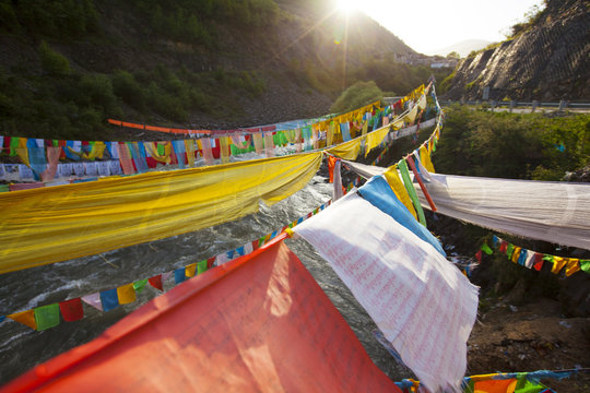 Tibetan Prayers Flags on the River at Sunset