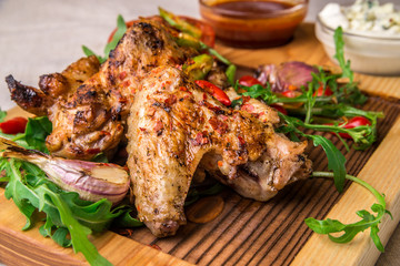 Appetizing fried chicken wings, decorated with herbs. Horizontal frame