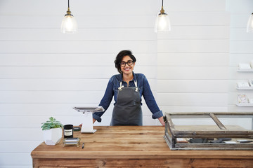 Portrait of hispanic woman business owner in her artisan retail store