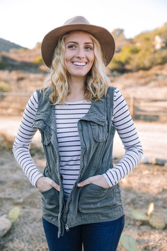 Outdoor lifestyle portrait of young blonde woman.
