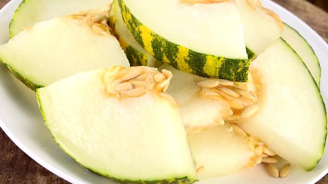 Fresh Melons (rotating on a wooden plate; seamless loopable; 4K)