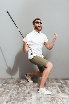 Full length image of a Screaming golfer in sunglasses