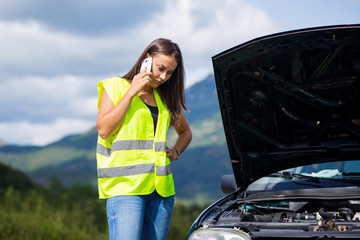 Pretty young white girl calling for help after her car broke down