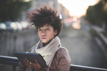 beautiful black curly hair african woman using tablet