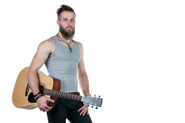 A charismatic man with a beard holds an acoustic guitar, on a white isolated background. Horizontal frame