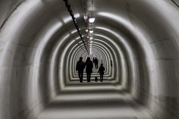 Silhouette of people walking in the tunnel.Silhouette of people walking in the tunnel.