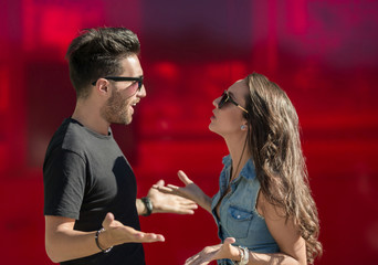 Young couple arguing and gesticulating