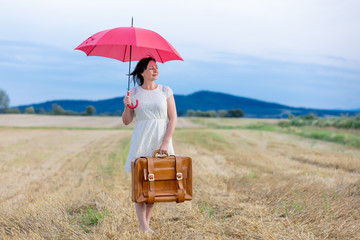 Portrait of senior woman with travel suitcase