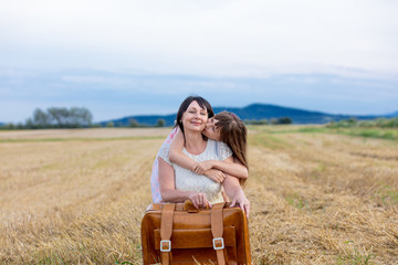 grandmother and granddaughter with suitcase