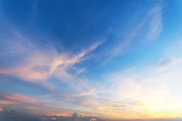Sky background at sunset,Sky blue and orange light of the sun through the clouds in the sky