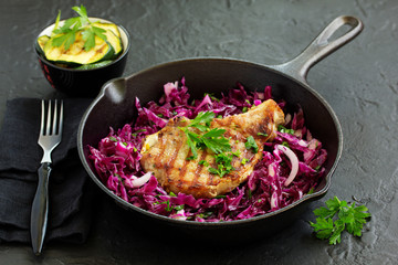 Pork cutlet on a bone with a salad of red cabbage.