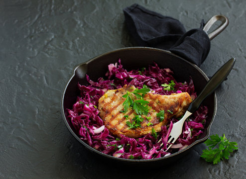 Pork cutlet on a bone with a salad of red cabbage.