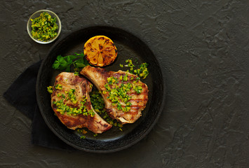 Pork cutlet on a bone with gremolat sauce.